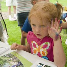 A girl showing her finger painting